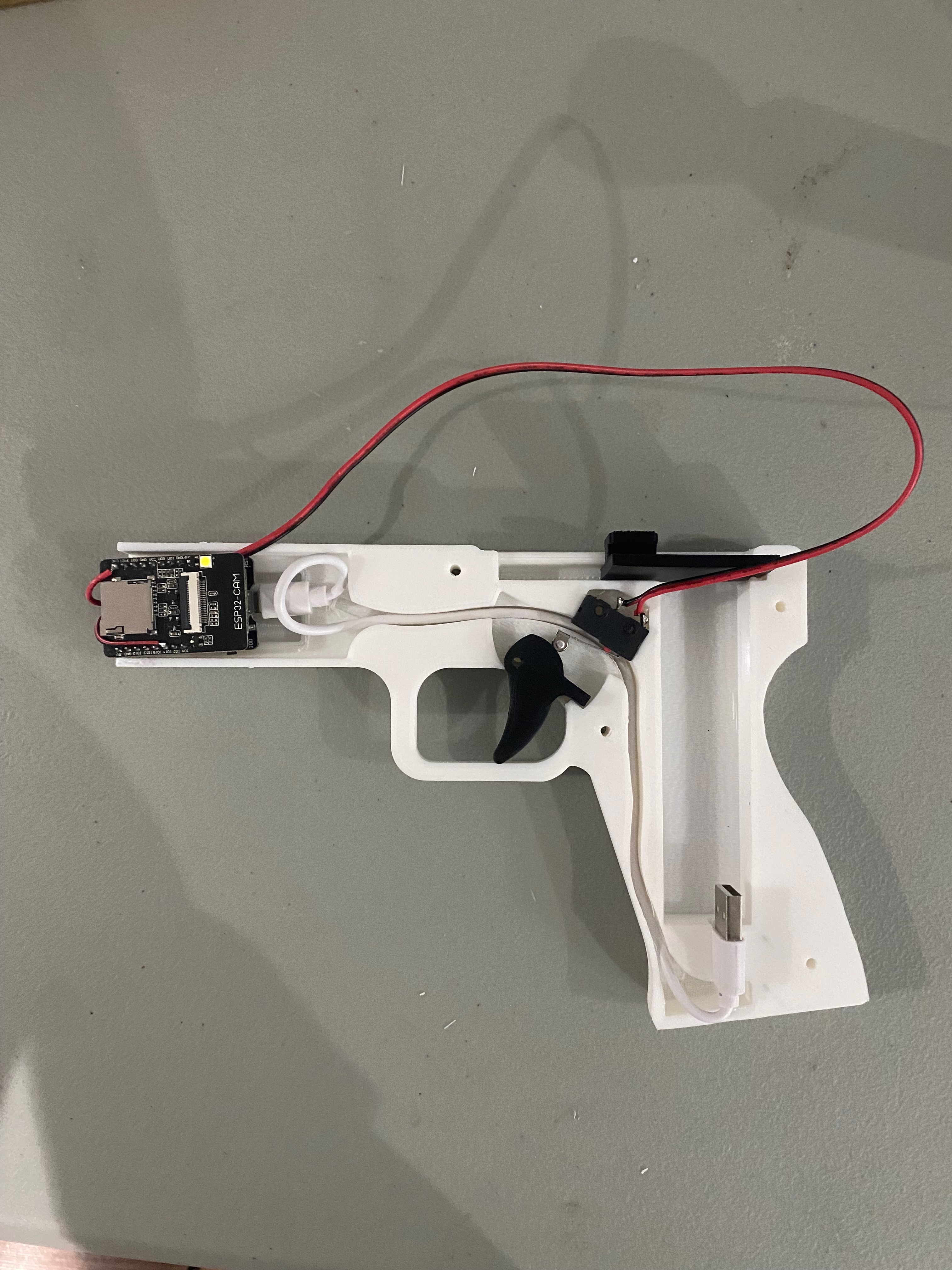 Internal electronics — ESP32-CAM module, trigger switch, and wiring harness